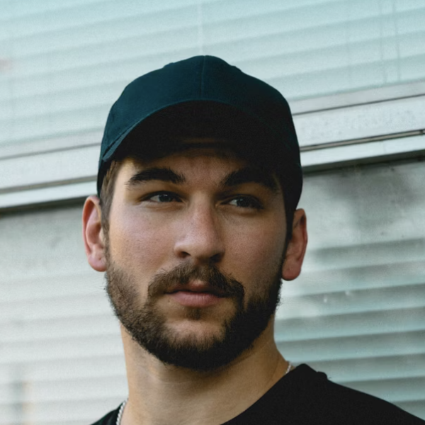 Bearded man in green cap outside
